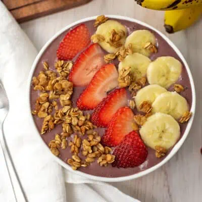 Strawberry banana acai bowl with sliced banana and strawberries.