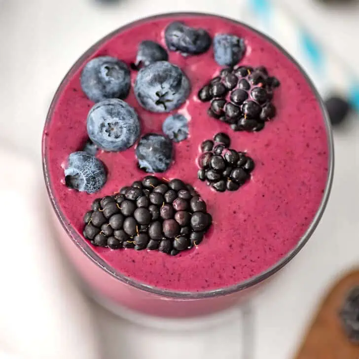 Blackberry blueberry smoothie with blueberries and blackberries on top.