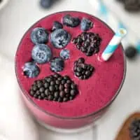 Blackberry blueberry smoothie garnished with blueberries and blackberries.