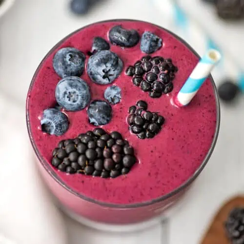Blackberry blueberry smoothie garnished with blueberries and blackberries.