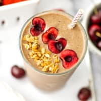Cherry kale smoothie with cherry and granola toppings.