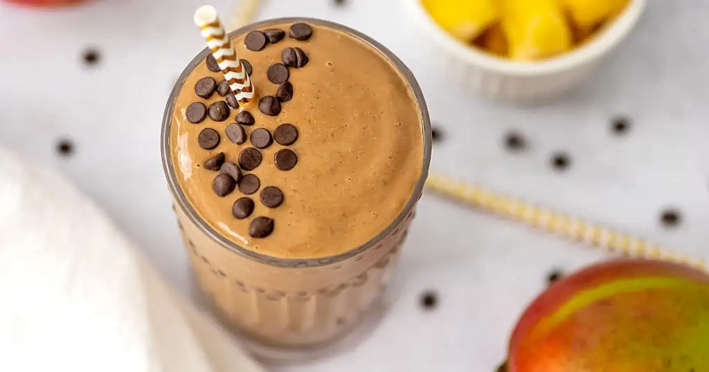 Chocolate mango smoothie with mini chocolate chips on top.