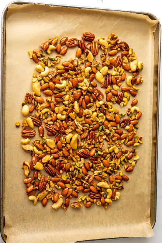 Maple nuts on parchment paper before roasting.
