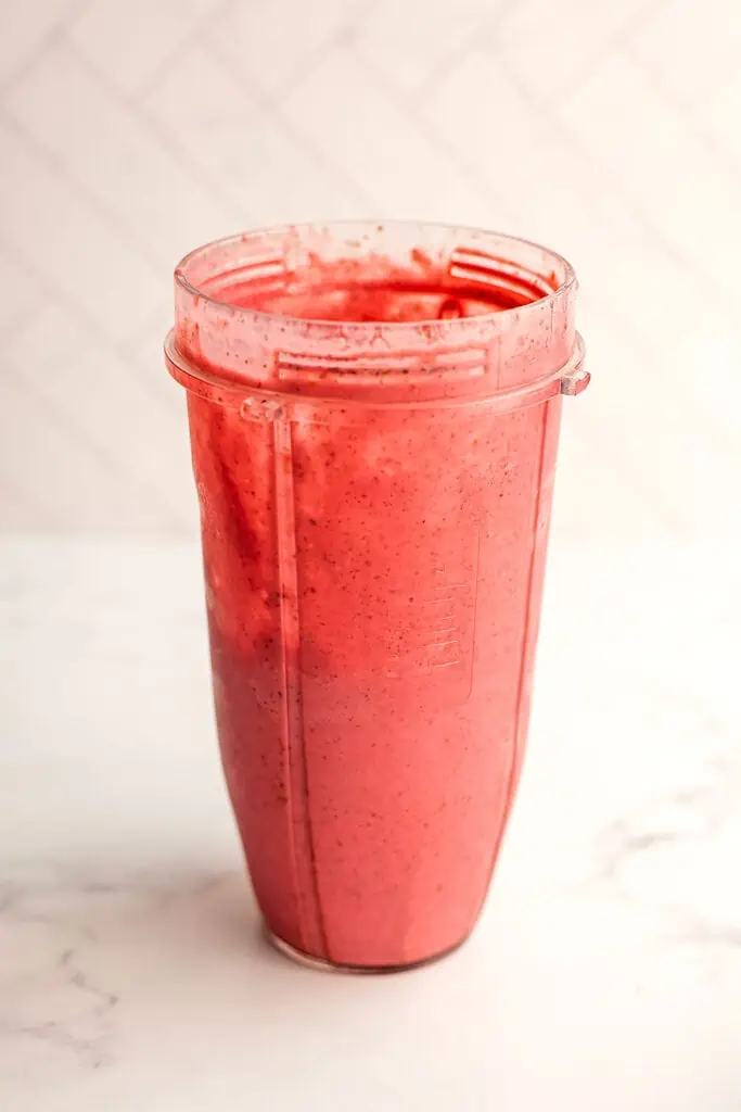 Peach raspberry smoothie after blending in a blender.