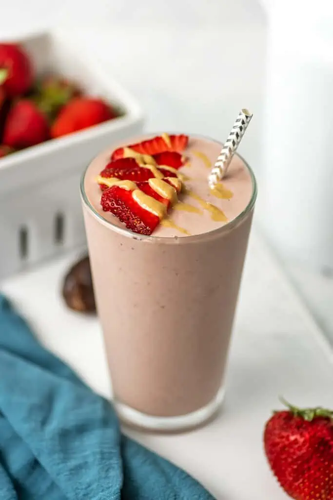 Strawberry cauliflower smoothie with sliced strawberries on top.
