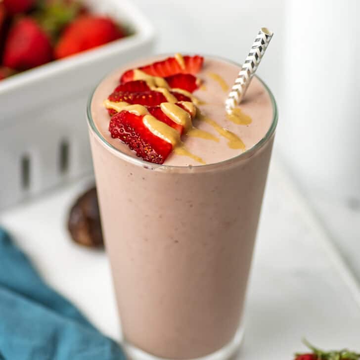 Strawberry cauliflower smoothie with sliced strawberries on top.