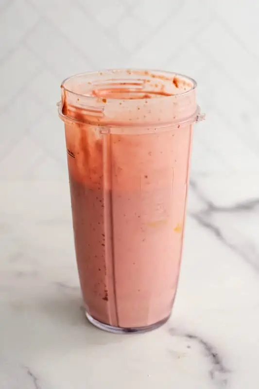 Strawberry smoothie no banana in a blender cup after blending.