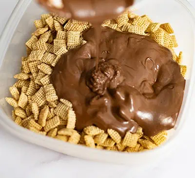 Melted chocolate and peanut butter over corn cereal.
