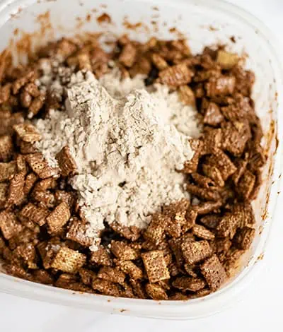 Protein powder poured over chocolate peanut butter cereal.