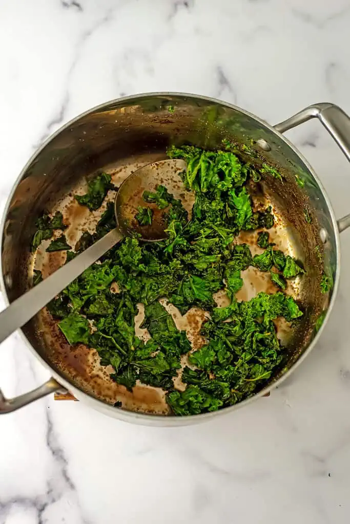 Balsamic kale after wilting in stainless steel pot.