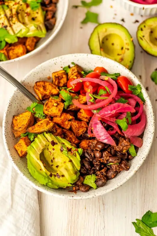 Fork in sweet potato black bean bowl.