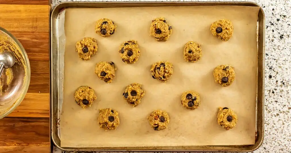 Pecan chocolate chip cookies on baking sheet before baking.