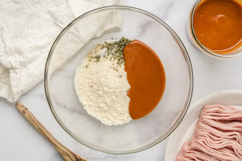 Honey chipotle sauce, almond flour and spices in a glass bowl.