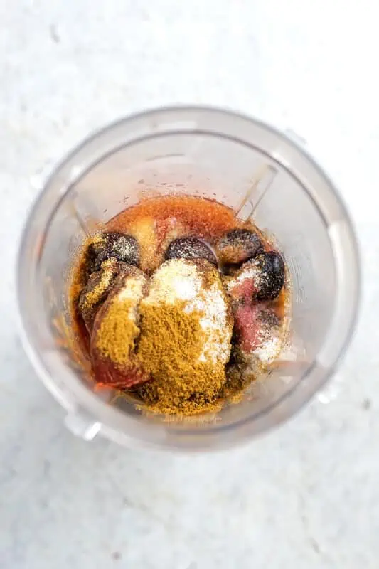 Bullet blender jar filled with ingredients to make cherry chipotle bbq sauce.