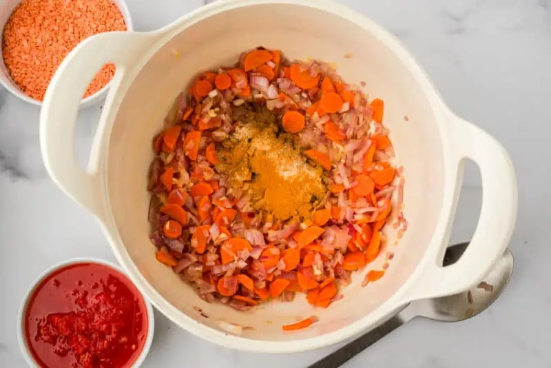 Spices added to pot with sauteed veggies.