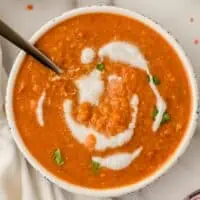 Moroccan red lentil soup with coconut milk drizzled on top.