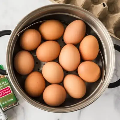 Pot with steamer basket with eggs in basket.