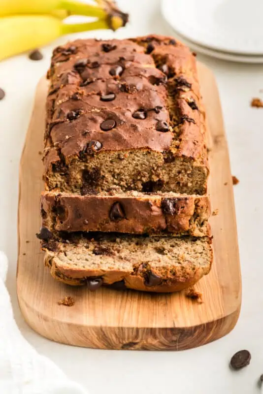 Slices of protein banana bread on a wood cutting board.