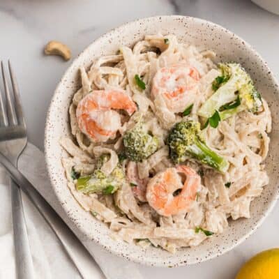 Bowl filled with creamy lemon broccoli shrimp pasta.