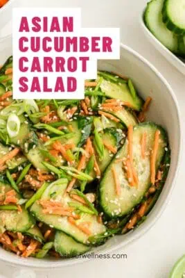 Large bowl filled with asian cucumber carrot salad.