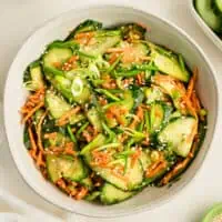 Cucumber carrot salad in white bowl.