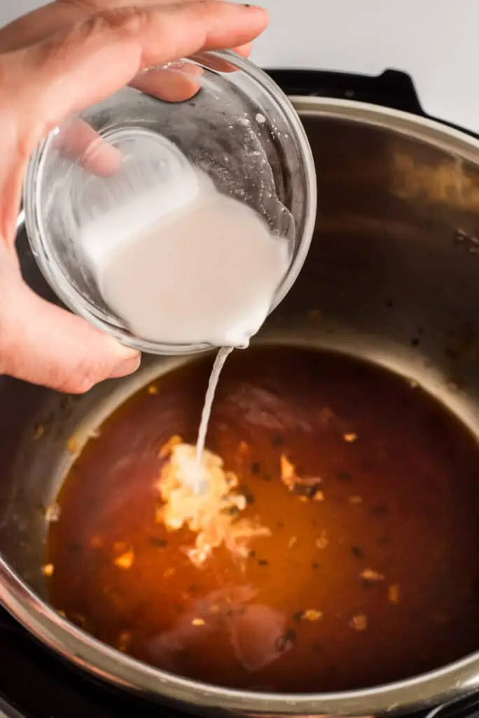 Arrowroot slurry being poured into instant pot.