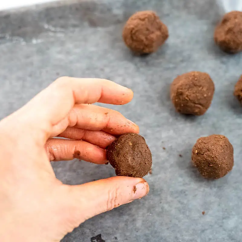Chocolate mint protein balls on wax paper lined sheet before dipping in chocolate.