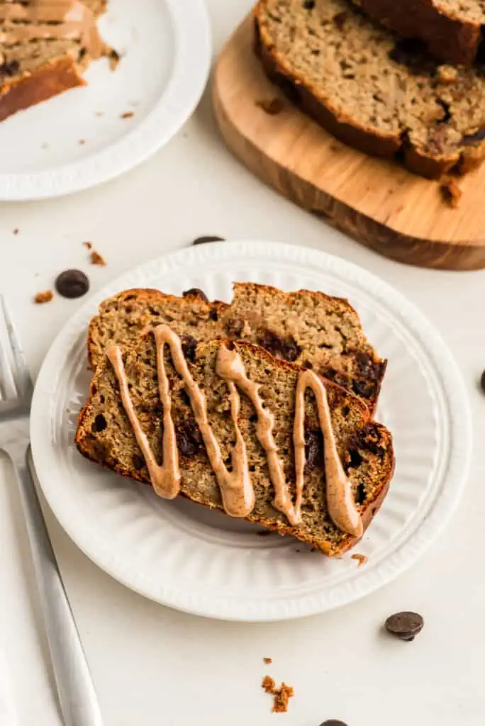 Almond butter drizzled on protein banana bread slices.