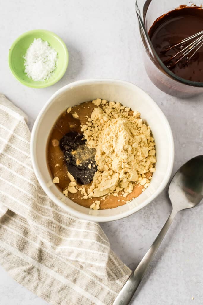 Ingredients to make protein peanut butter filling in a white bowl.