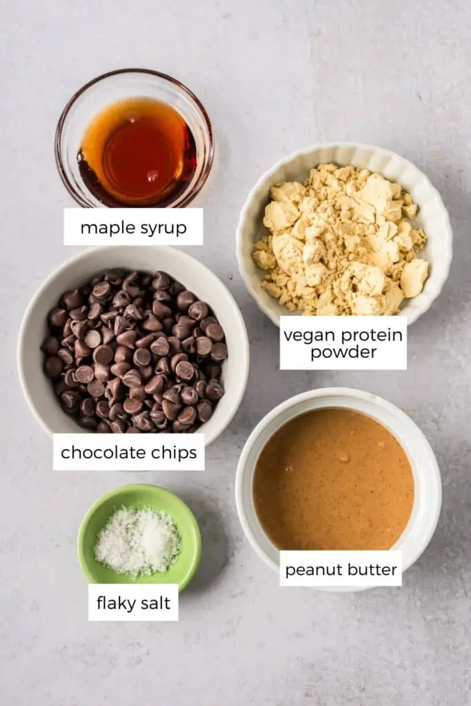 Ingredients to make peanut butter protein cups in a bowl on a cement countertop.