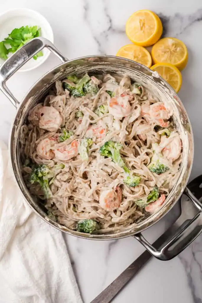 Broccoli shrimp pasta with creamy lemon sauce after stirring the ingredients together in pot.