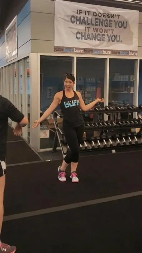 Samantha in front of weights at her new gym