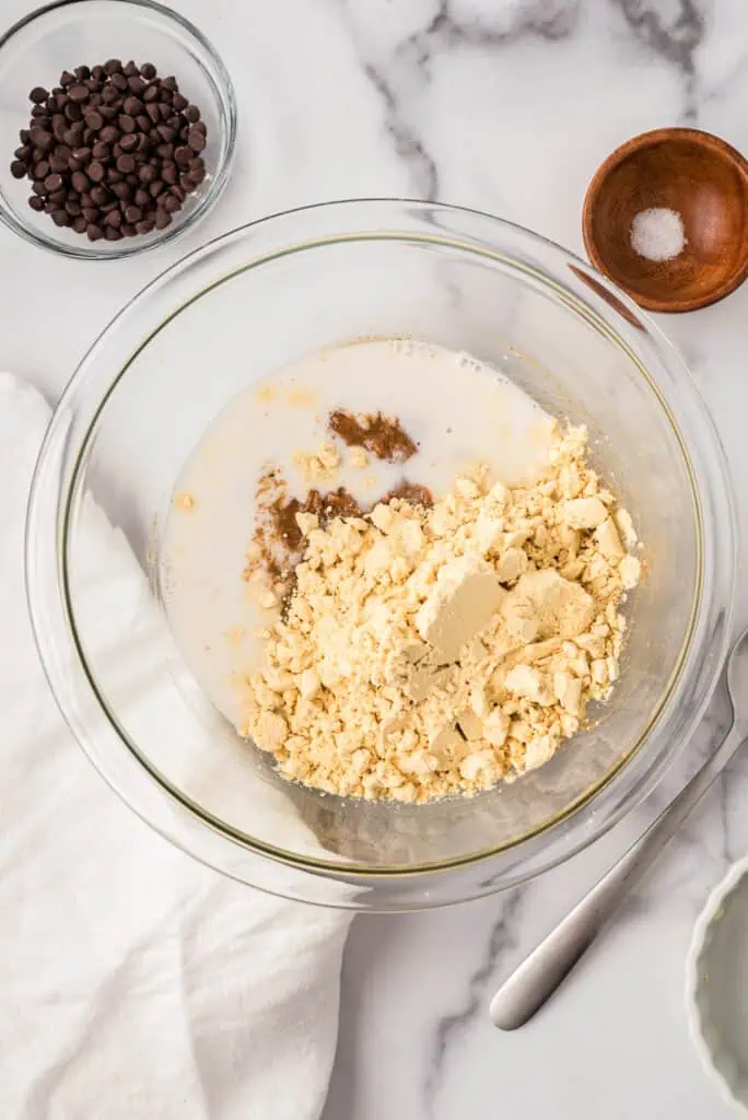 Protein powder and dairy free milk added to bowl with almond butter mixture.