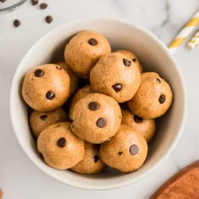 Chocolate chip almond butter protein balls in a white bowl.