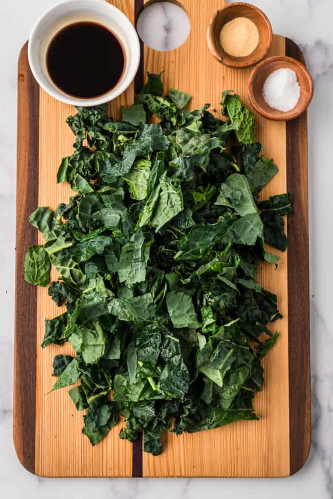 Chopped kale on wood cutting board.