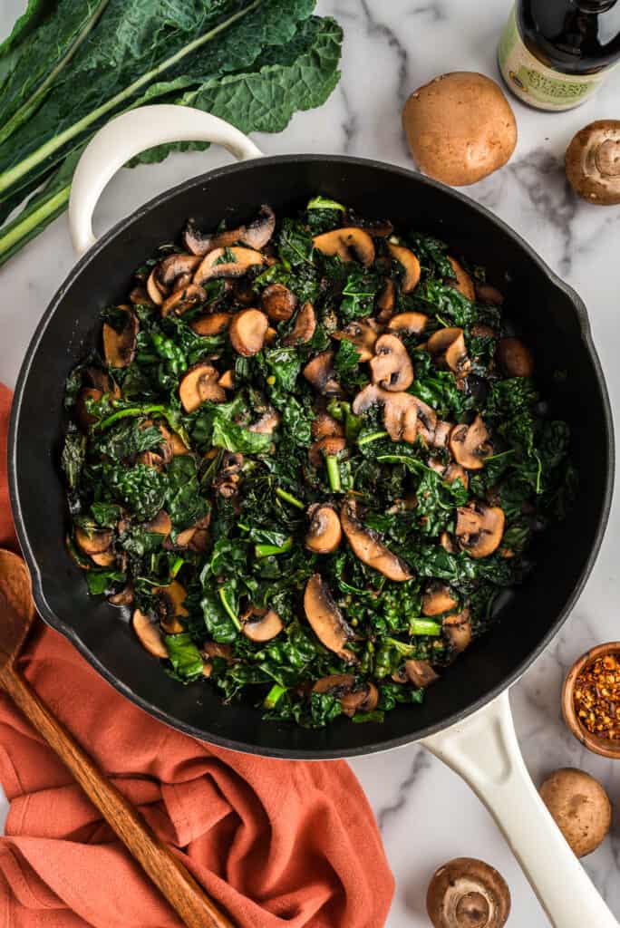 Large skillet filled with balsamic kale mushroom recipe.