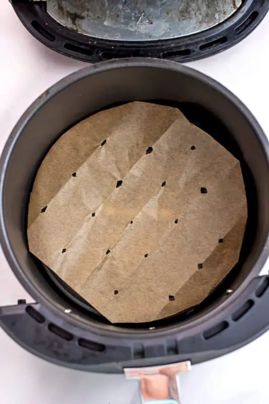 Parchment paper in air fryer basket.