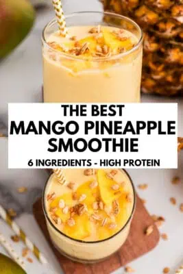 Mango pineapple smoothie in a glass with chopped fruit on top.