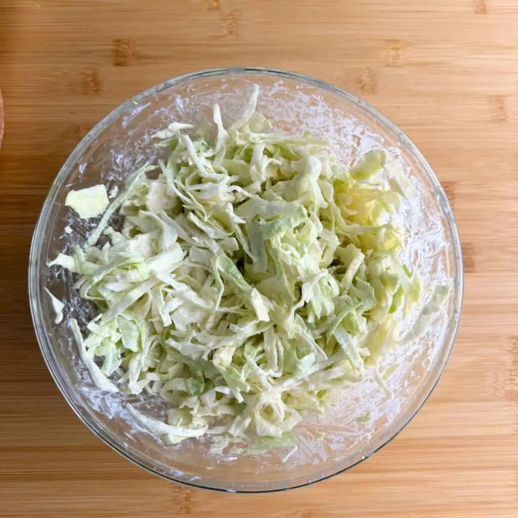 Greek yogurt slaw in a glass bowl.