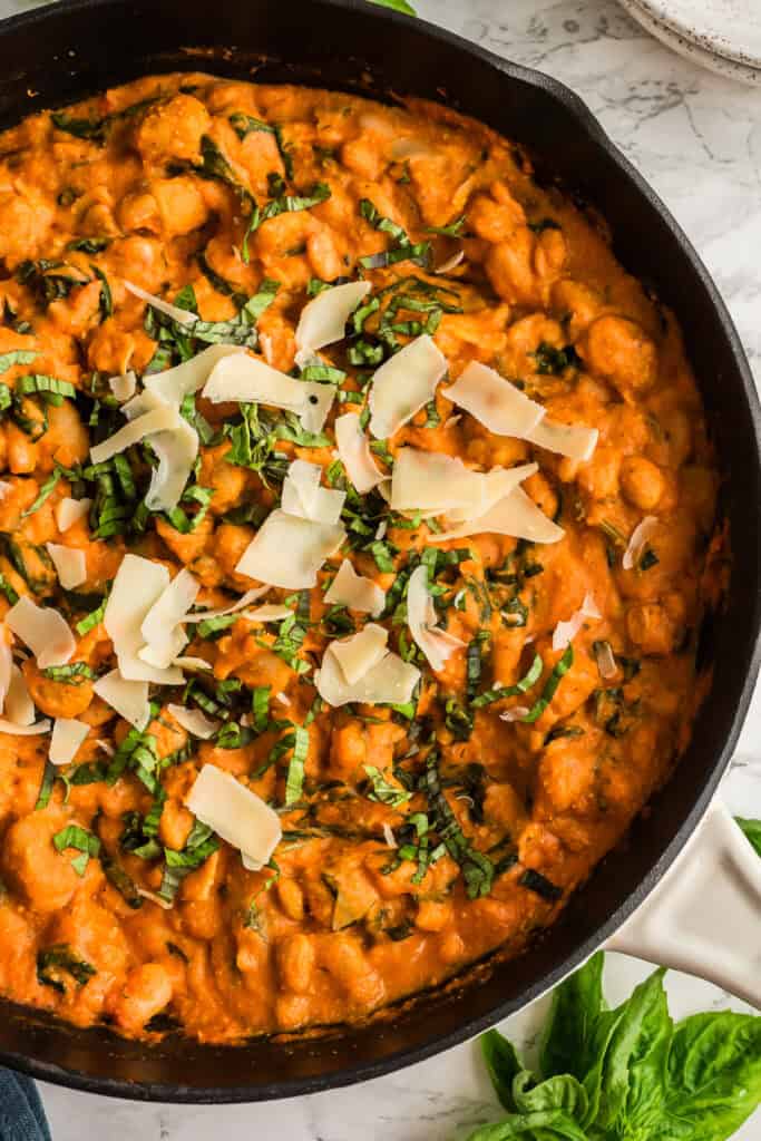 Gnocchi in marinara sauce in a large cast iron skillet.