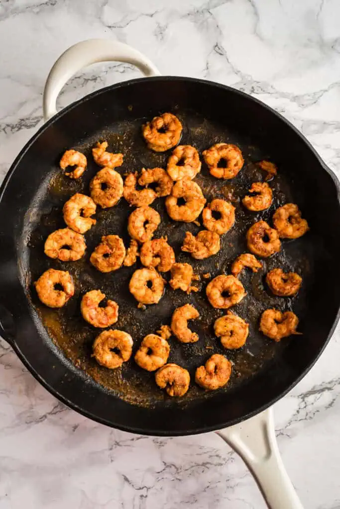 Blackened shrimp in cast iron skillet after cooking.