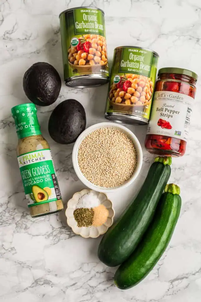 Ingredients to make green goddess bowls on a marble countertop.