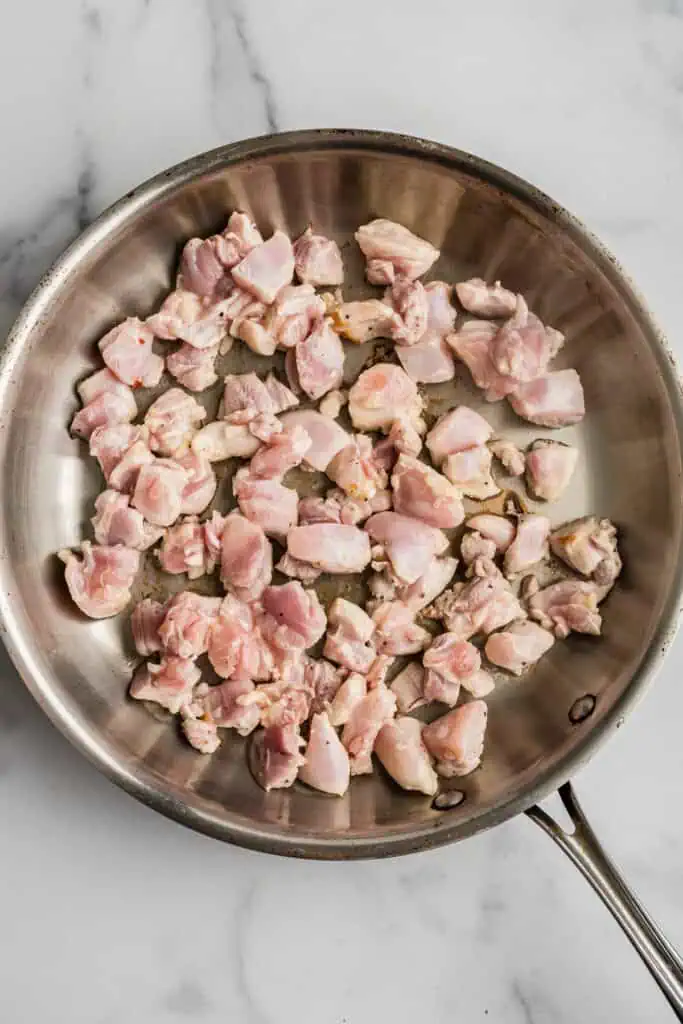 Italian cubed chicken in skillet.