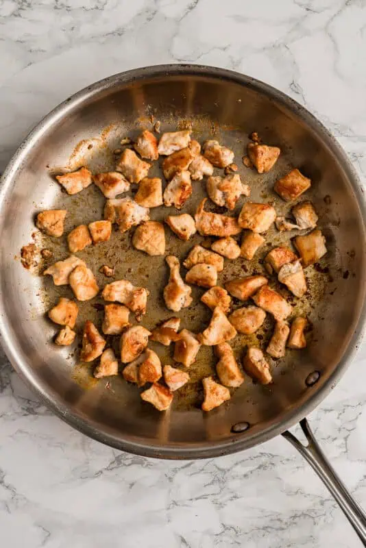 Greek chicken bites in a skillet after cooking.