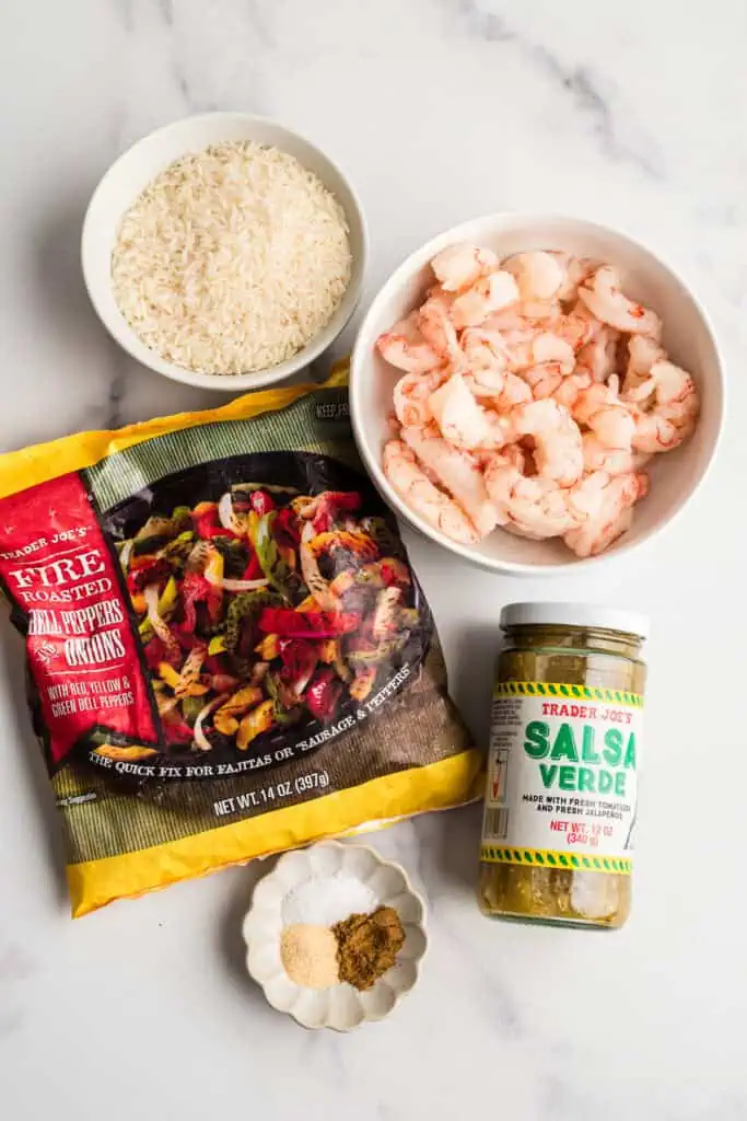 ingredients to make salsa verde shrimp and rice on a marble countertop.