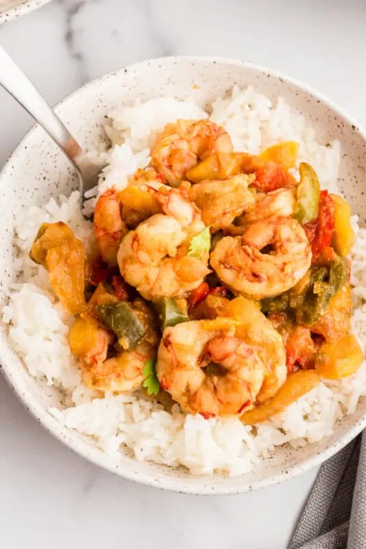Large bowl filled with rice and salsa verde shrimp.