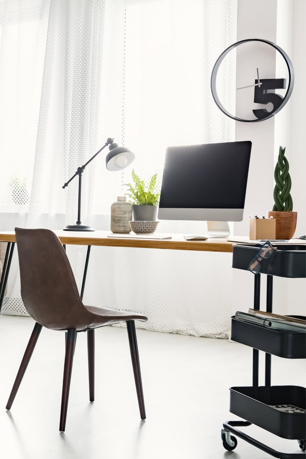 White office with a brown chair and computer monitor on desk.