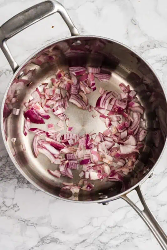 Chopped red onions in a pot.