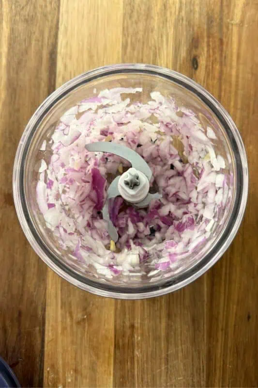 Finely chopped red onion in a food processor.