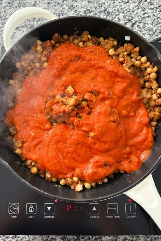 Marinara added to skillet with potatoes and chickpeas.
